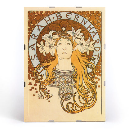Art Nouveau poster of Sarah Bernhardt with flowing hair floral crown and lilies by Alphonse Mucha from La Plume, framed and displayed in modern living room decor
