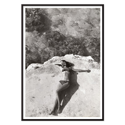 Woman in bikini lying on platform near water in Montego Bay Jamaica artwork by Nickerson Paine poster, with black aluminium frame on white background