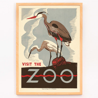 Visit the zoo poster by Federal Art Project WPA Pennsylvania showing two herons standing on a rock with text by the artist, framed and displayed in modern living room decor