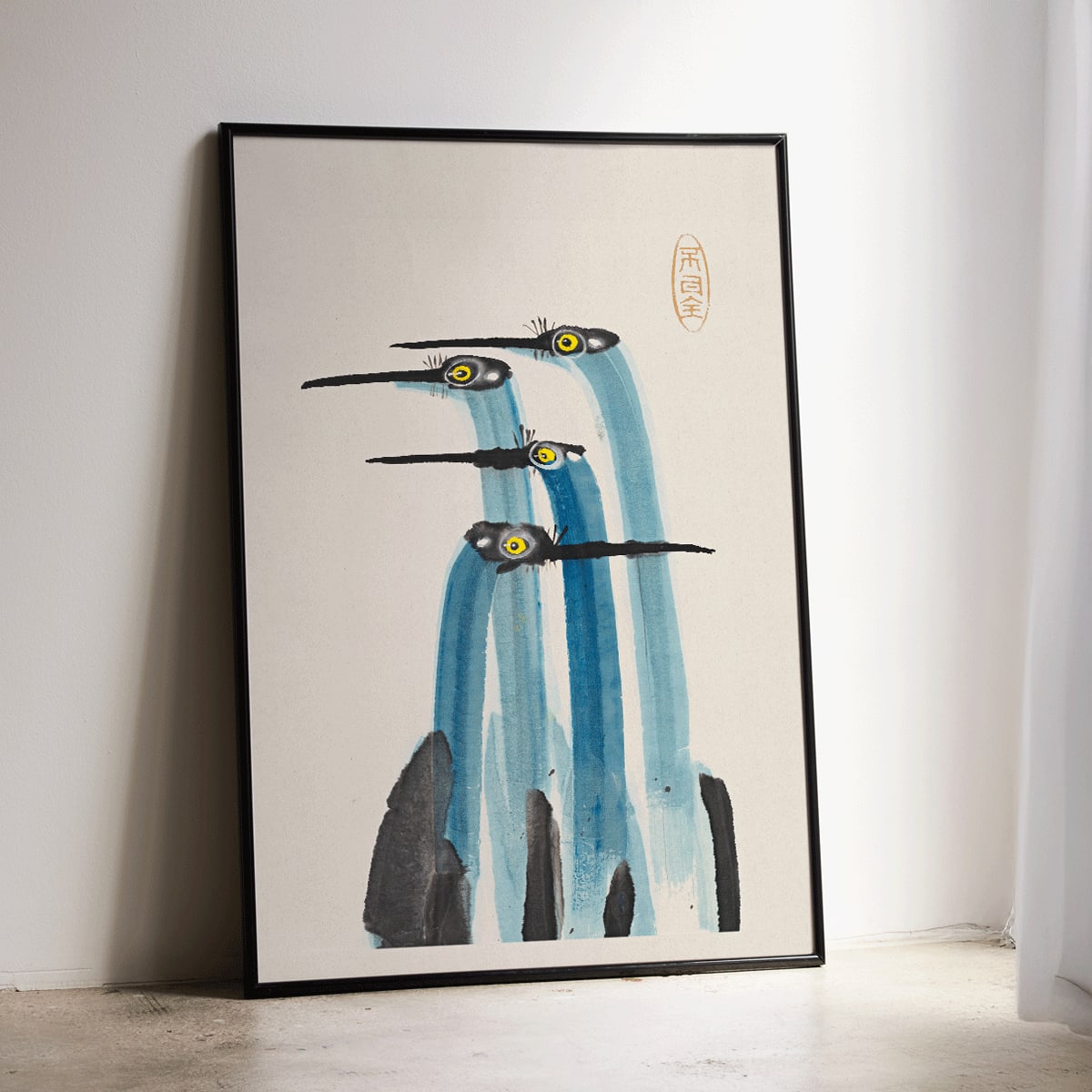 Watercolor painting of three blue cranes titled Blue Japanese Crane by Ohara Koson and Anonymous poster, framed and displayed in modern living room decor