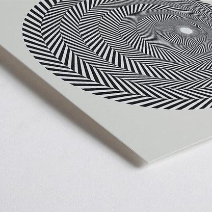 Closeup detail of Bridget Riley Blaze Exhibition Poster featuring hypnotic black and white spiral geometric design on light background