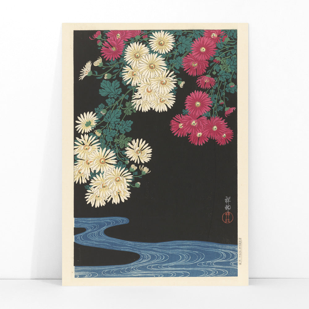 Chrysanthemums and Running Water by Ohara Koson Japanese art poster with yellow and pink flowers over blue water on black background, framed and displayed in modern living room decor