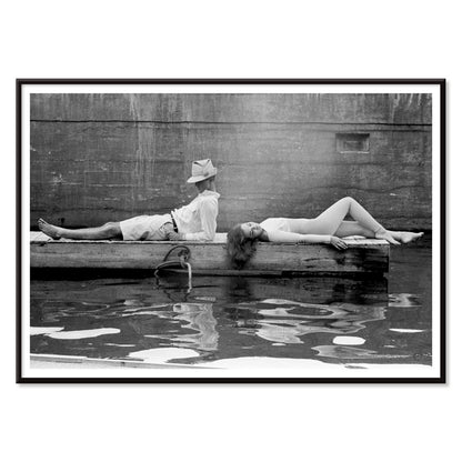 Marquess of Tavistock Henry Robin Ian Russell and Henrietta Tiarks relaxing on a dock in Bermuda by Toni Frissell poster, with black aluminium frame on white background