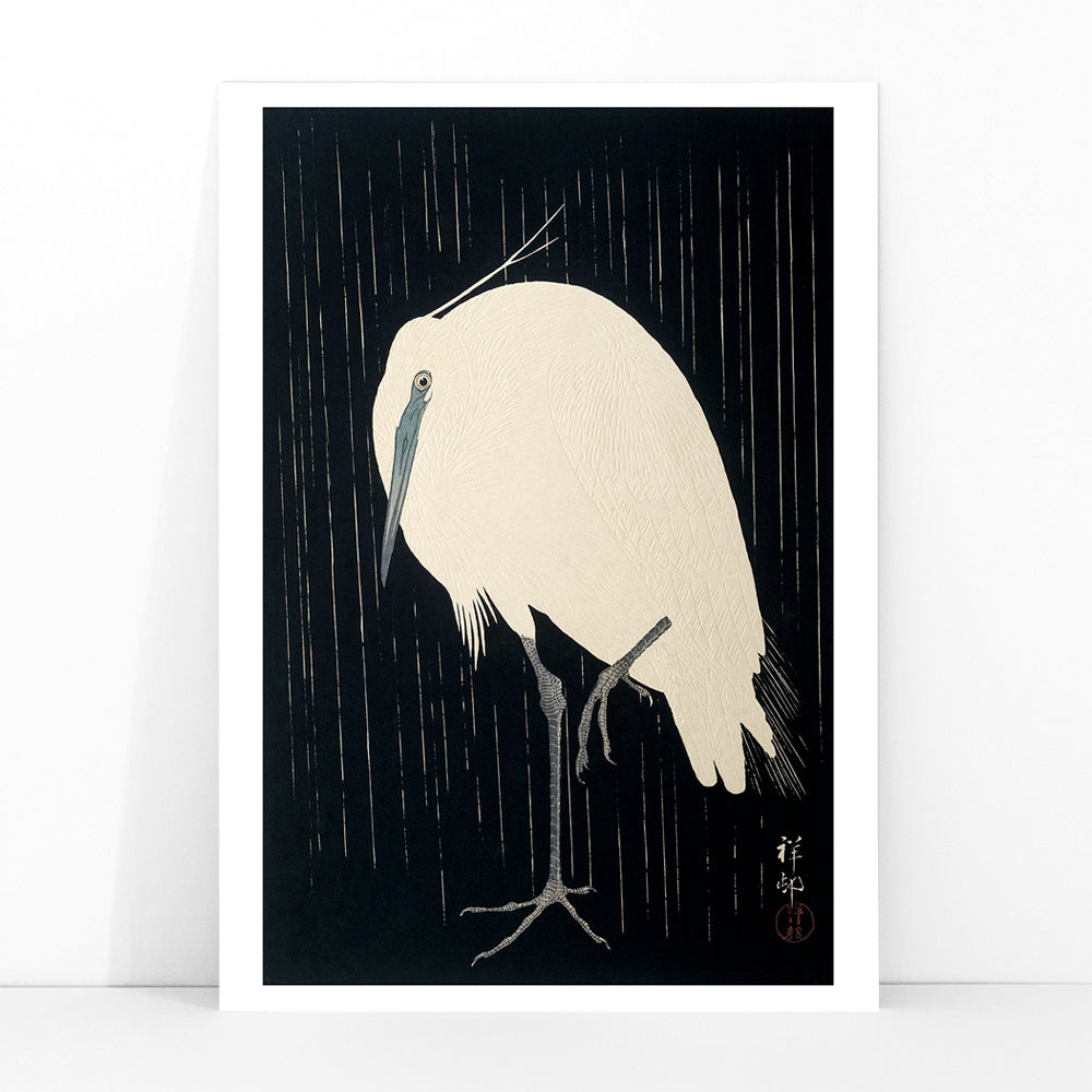 White egret standing in the rain art print poster with dark background by Ohara Koson, framed and displayed in modern living room decor