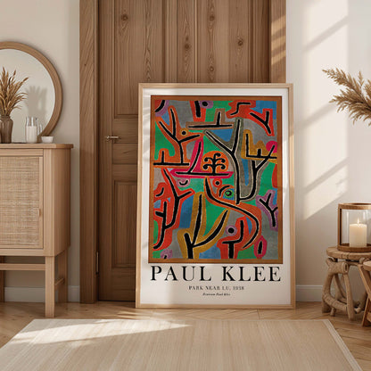 Exhibition poster of Park Near Lu by Paul Klee featuring vibrant abstract shapes and bold lines in diverse colors, framed and displayed in modern living room decor