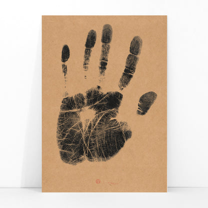 Black ink handprint artwork titled The Artists Left Hand by Henri Charles Guerard on beige background, framed and displayed in modern living room decor