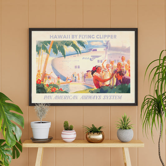 Vintage travel poster of Pan American Airways seaplane in Hawaii with people greeting each other with leis and Hawaiian welcome scene, framed and displayed in home decor