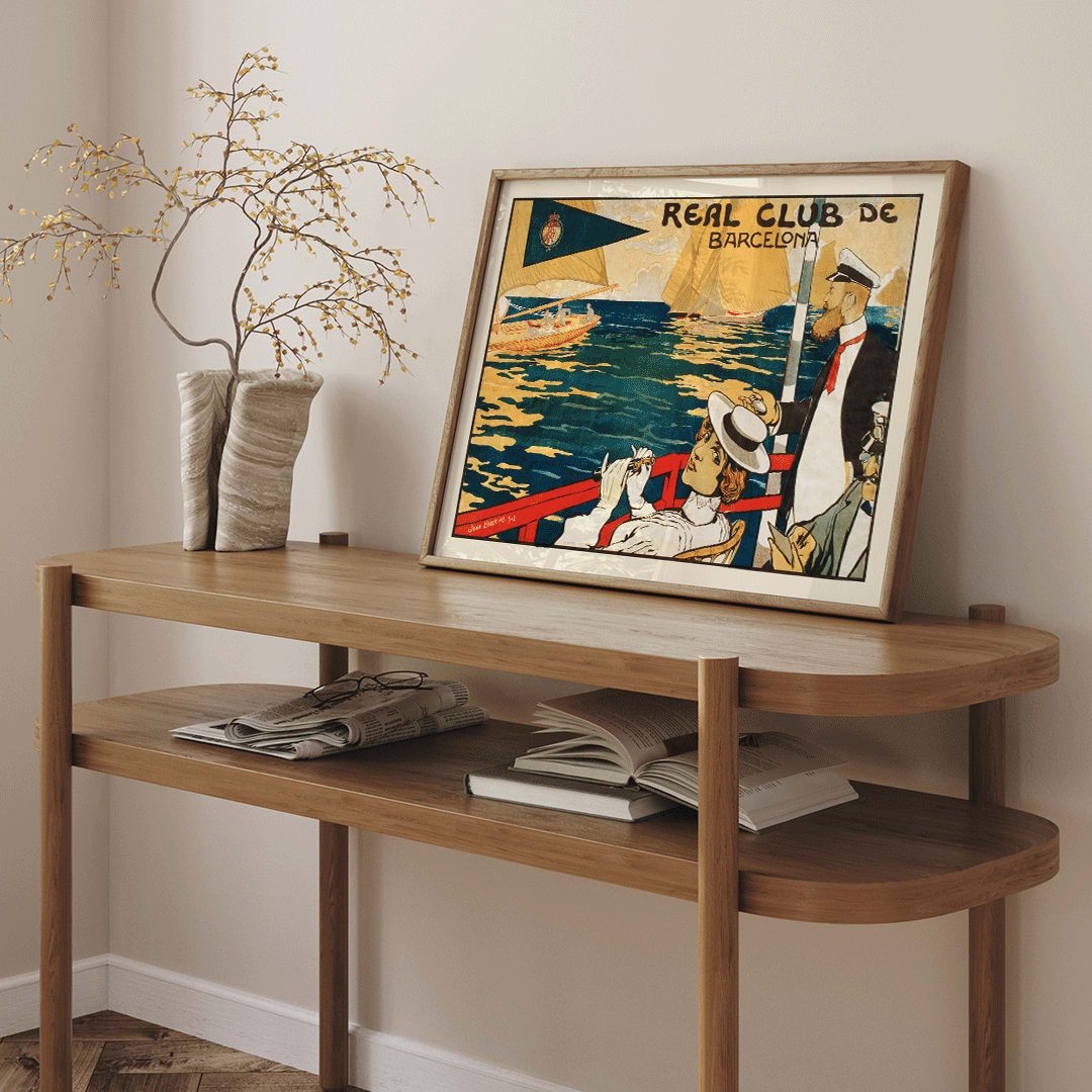 Sailing scene and poster for Real Club de Barcelona by Joan Llaverias featuring elegantly dressed figures and people in maritime attire with sailboats in the background, framed and displayed in home decor
