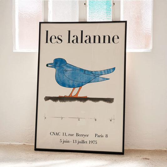 Les Lalanne Exhibition poster by Francois Xavier Lalanne featuring a stylized blue bird with orange legs on beige background, framed and displayed in home decor