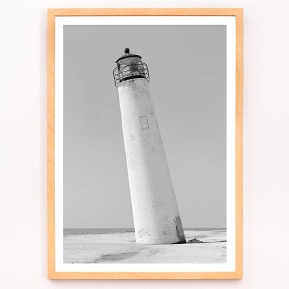 Cape Saint George Lighthouse poster featuring a tilted lighthouse on a sandy beach in Apalachicola Franklin County Florida, framed and displayed in modern living room decor