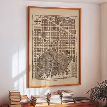 Detailed vintage map of Barcelona poster artwork featuring a city map layout with illustrated streets and blocks, framed and displayed in modern living room decor