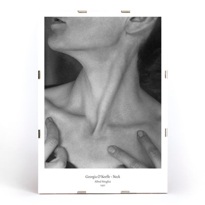 Black and white portrait of Georgia O Keeffe neck and hands by Alfred Stieglitz wall art poster photography decor, framed and displayed in modern living room decor