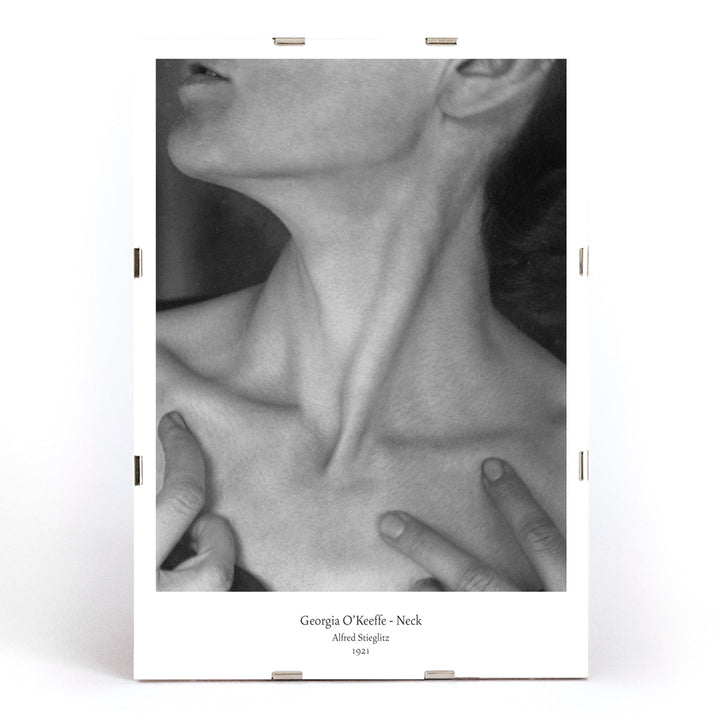 Black and white portrait of Georgia O Keeffe neck and hands by Alfred Stieglitz wall art poster photography decor, framed and displayed in modern living room decor