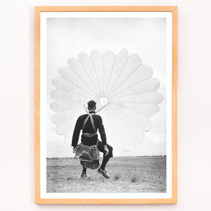 Air force parachuter landing and standing with deployed parachute by Ray Olsen poster, framed and displayed in modern living room decor