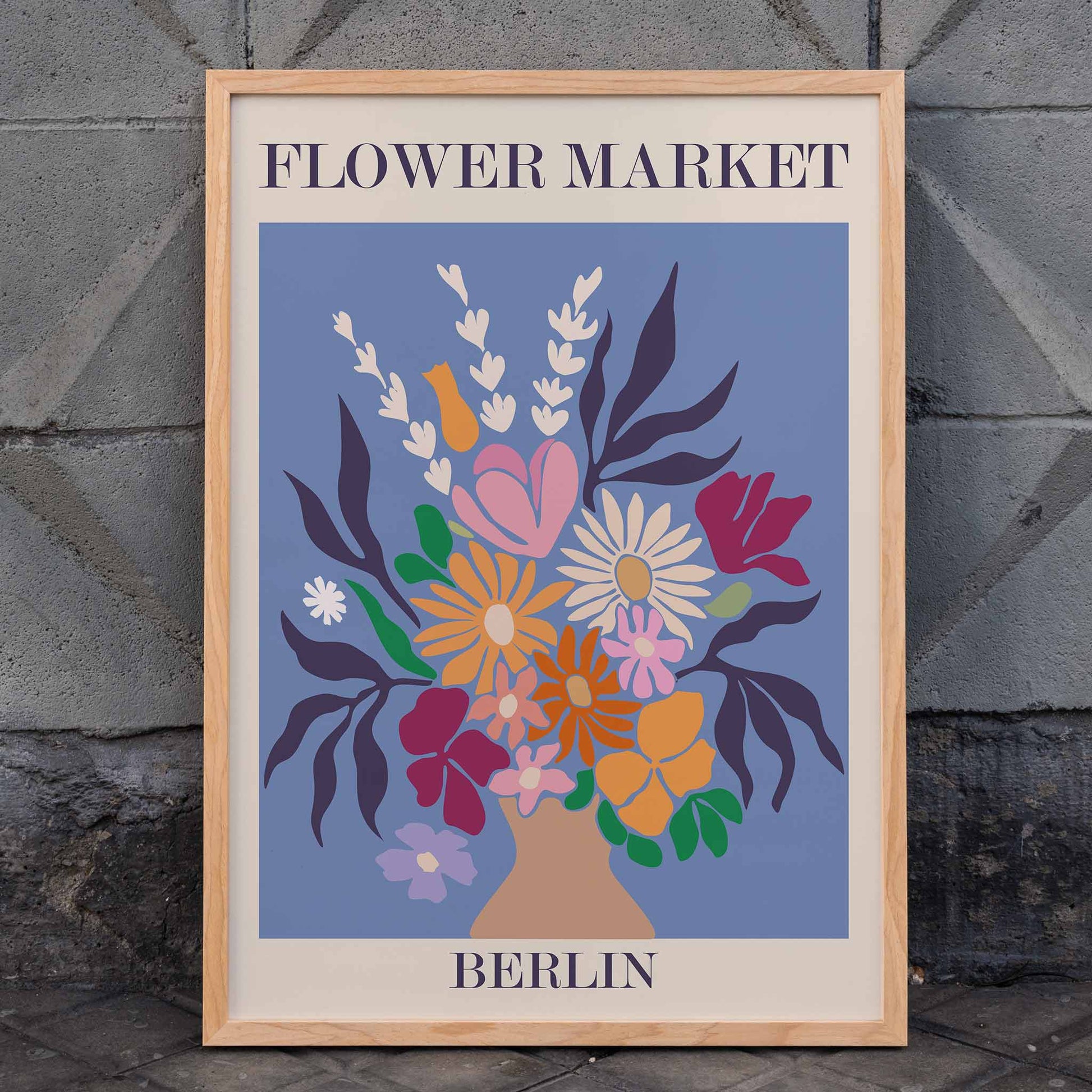 Colorful floral arrangement poster titled Flower Market Berlin by Moryarty featuring a vibrant bouquet of flowers on a blue background, framed and displayed in home decor