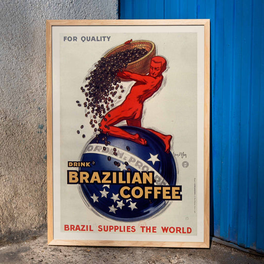Vintage poster by Jean dYlen promoting Brazilian coffee with a red figure pouring coffee beans over a globe, framed and displayed in home decor