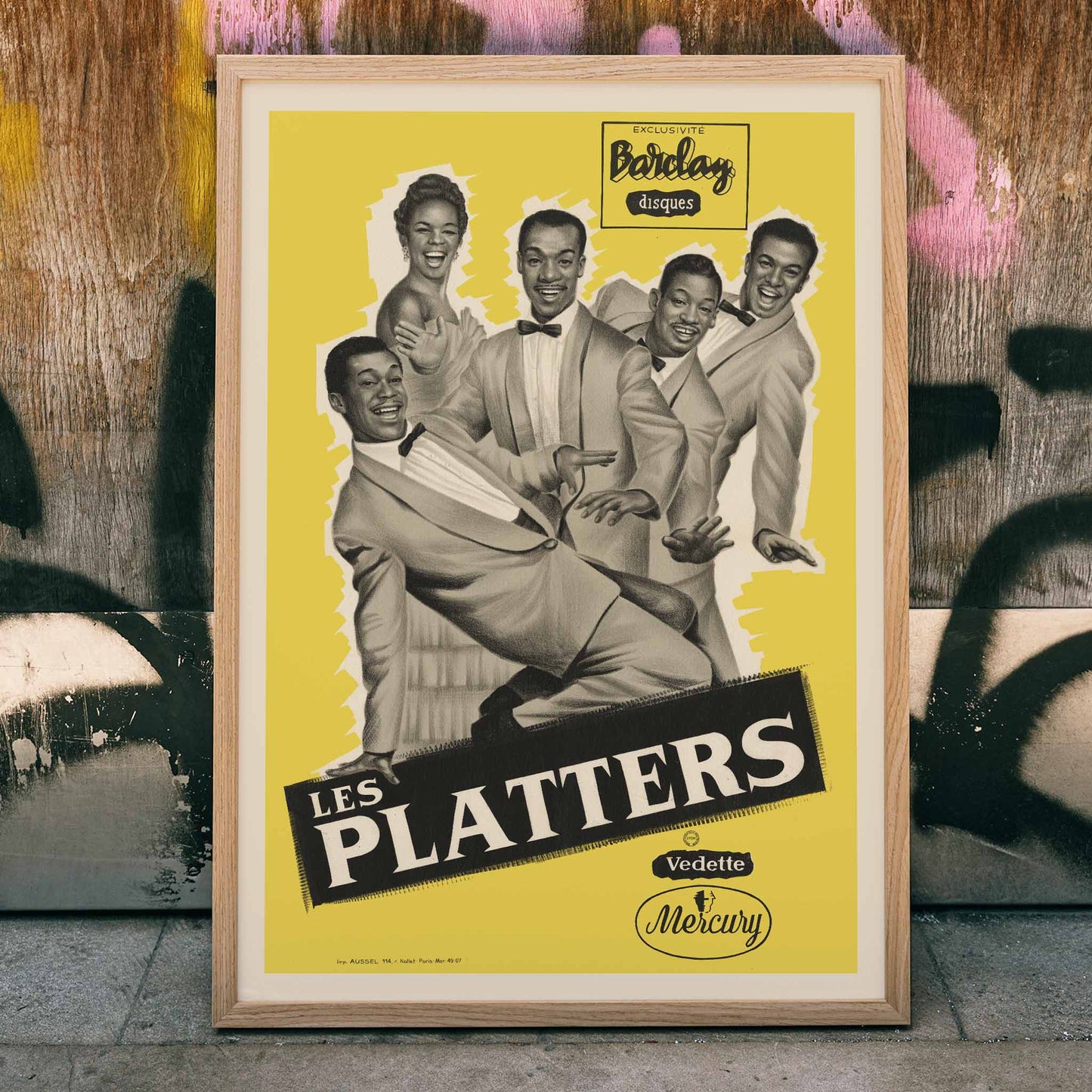 The Platters vintage music poster featuring Les Platters dancing and smiling against a yellow background for Barclay Disques artwork, framed and displayed in home decor