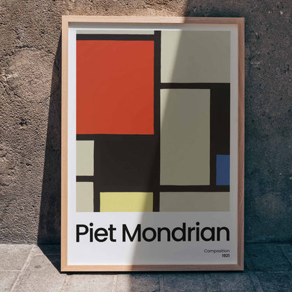 Abstract geometric art poster with bold primary colors and black lines by Piet Mondrian titled Composition, framed and displayed in home decor
