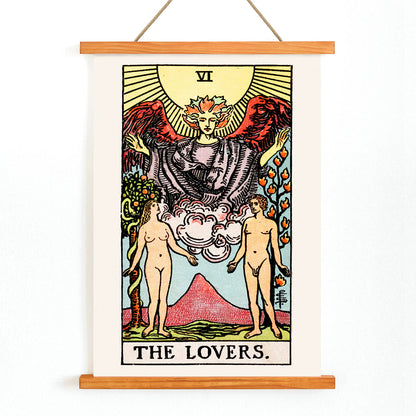 The Lovers Tarot card by Rider Waite featuring a winged angel above a man and woman in a garden illustration and poster, with wooden magnetic frame on white background