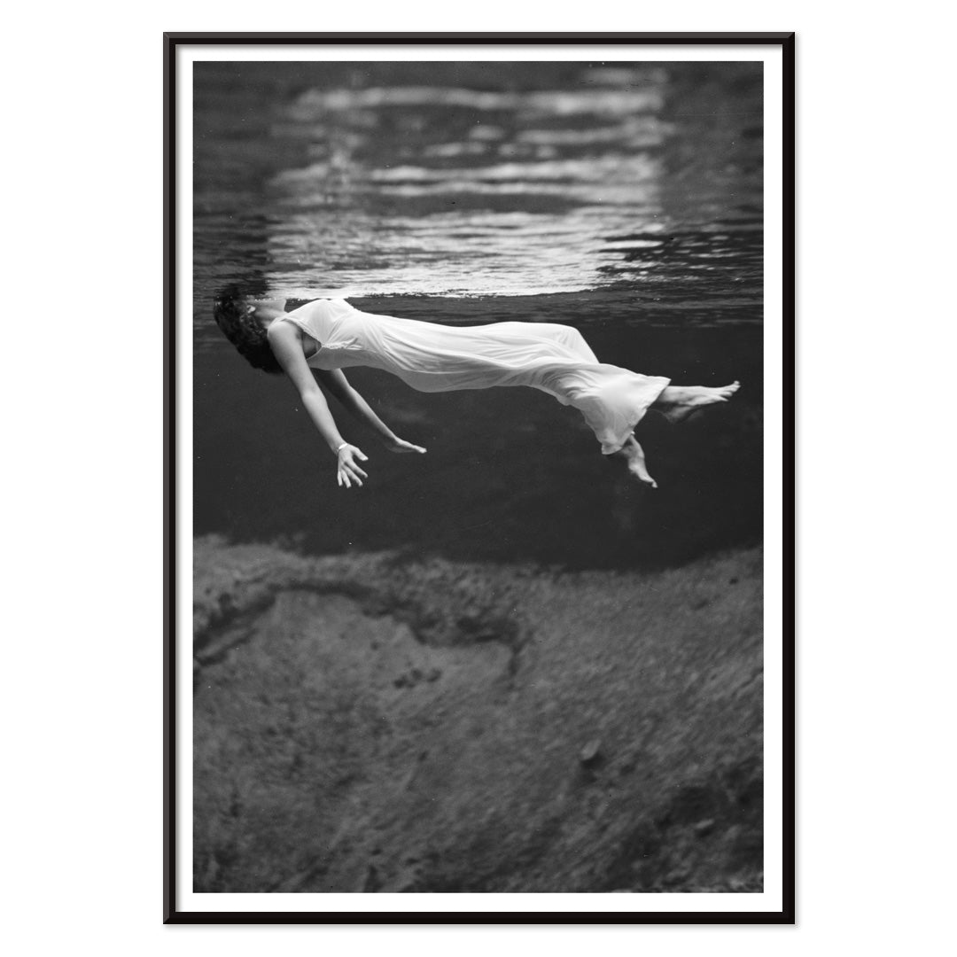 Underwater woman in white flowing dress at Weeki Wachee spring Florida by Toni Frissell, with black aluminium frame on white background