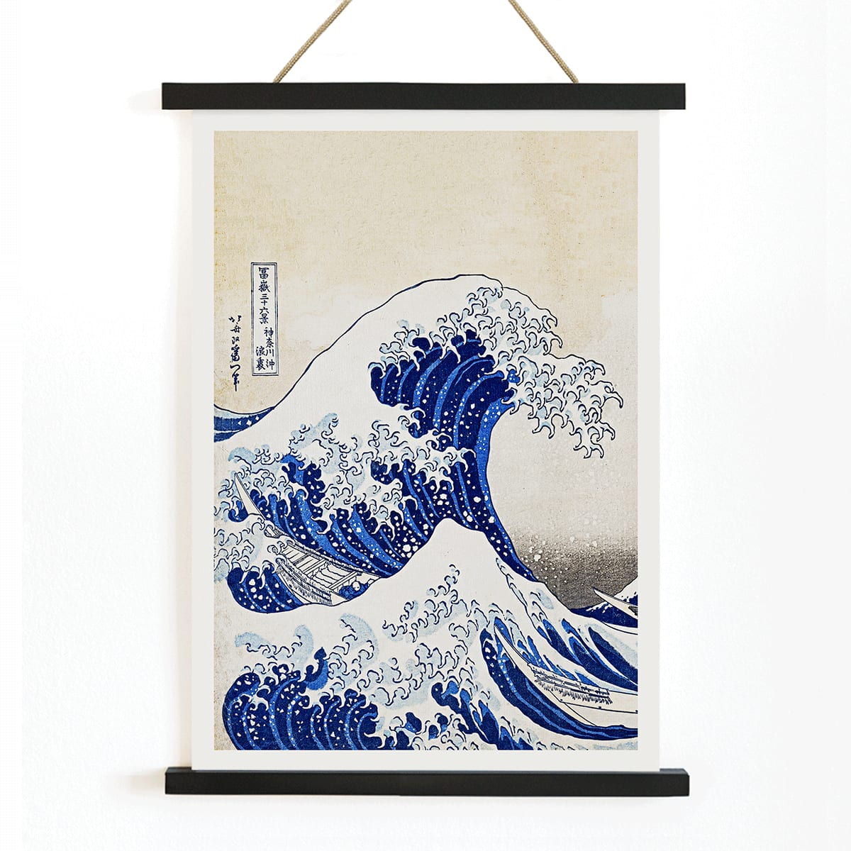 The Great Wave off Kanagawa by Katsushika Hokusai showing a dramatic large wave threatening small boats with Mount Fuji in the background, with wooden magnetic frame on white background