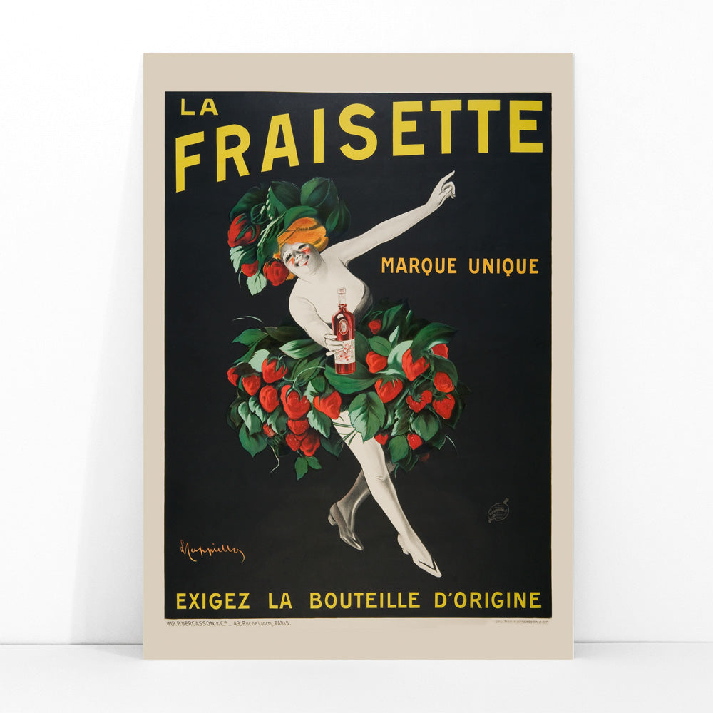 The Fraisette by Leonetto Cappiello poster featuring a whimsical woman in a strawberry costume holding a bottle of liqueur against a black background, framed and displayed in modern living room decor
